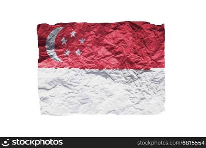 Close up of a curled paper on white background, print of the flag of Singapore