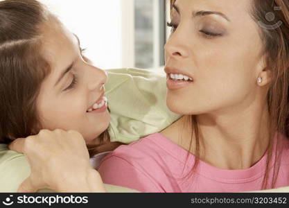 Close-up of a daughter hugging her mother