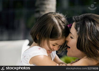 Close-up of a daughter hugging her mother