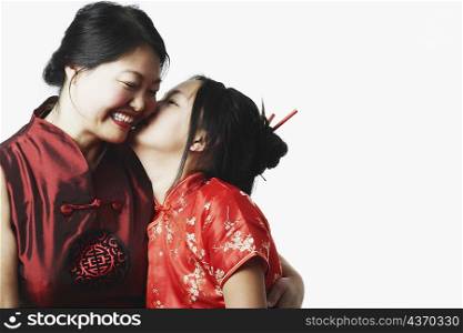 Close-up of a daughter kissing her mother