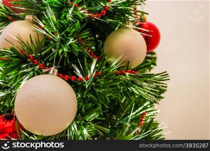 Close up of a decorated christmas tree with white and red balls