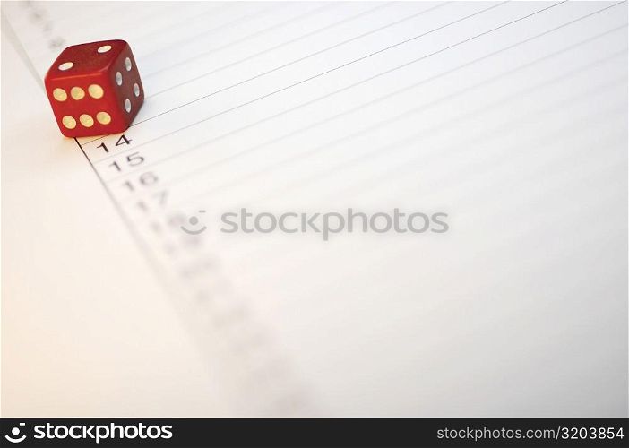 Close-up of a dice on paper