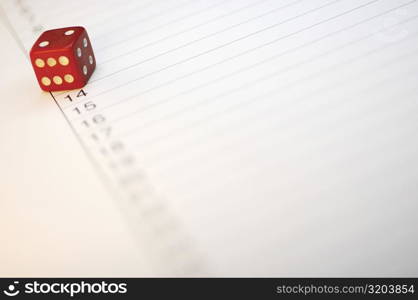 Close-up of a dice on paper