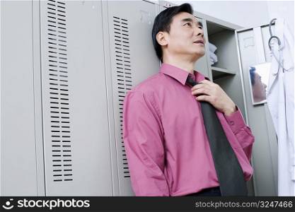 Close-up of a doctor leaning against a locker