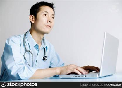 Close-up of a doctor operating a laptop