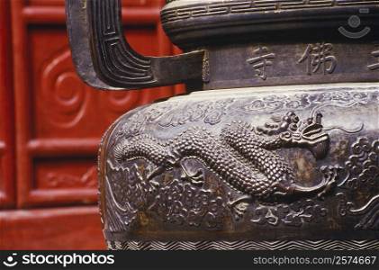 Close-up of a dragon on a decorative urn, China