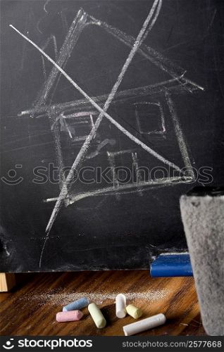 Close-up of a drawing of a house on a blackboard