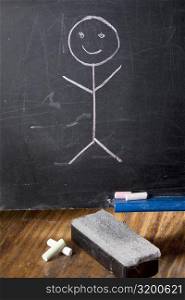 Close-up of a drawing of a stick figure on a blackboard