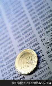 Close-up of a Euro cent coin on financial figures