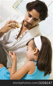 Close-up of a father eating a sandwich with his daughter