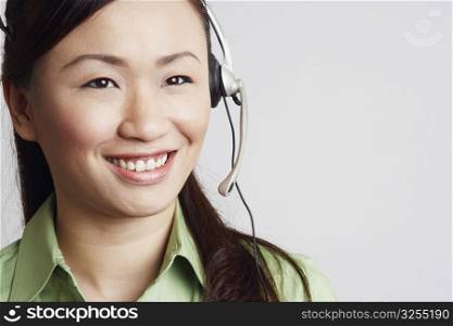 Close-up of a female customer service representative looking away and smiling