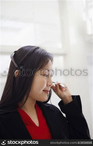Close-up of a female customer service representative talking on a headset