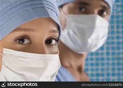 Close-up of a female doctor and a male doctor wearing surgical masks