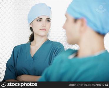 Close-up of a female doctor behind a male doctor