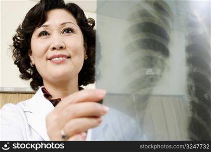Close-up of a female doctor examining an X-Ray