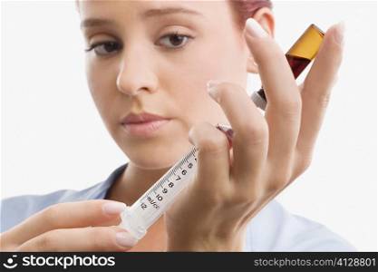 Close-up of a female doctor filling a syringe