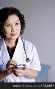 Close-up of a female doctor holding a personal data assistant