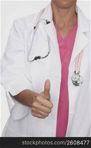 Close-up of a female doctor showing a thumbs up sign