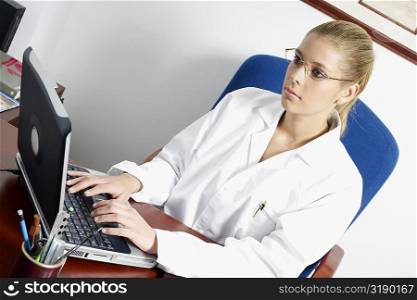 Close-up of a female doctor using a laptop