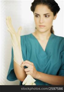 Close-up of a female doctor wearing a surgical glove