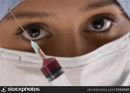 Close-up of a female doctor with a syringe