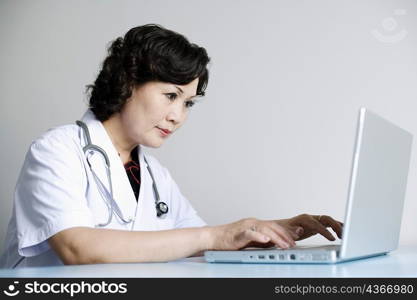 Close-up of a female doctor working on a laptop
