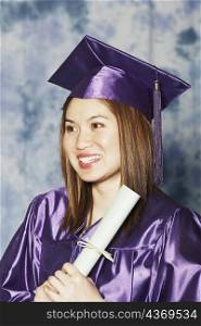 Close-up of a female graduate holding a diploma