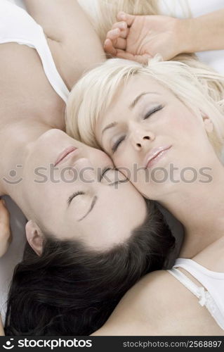Close-up of a female homosexual couple lying on the bed