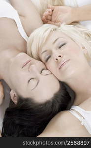 Close-up of a female homosexual couple lying on the bed