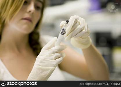 Close-up of a female nurse holding a syringe