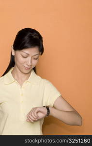 Close-up of a female office worker checking the time