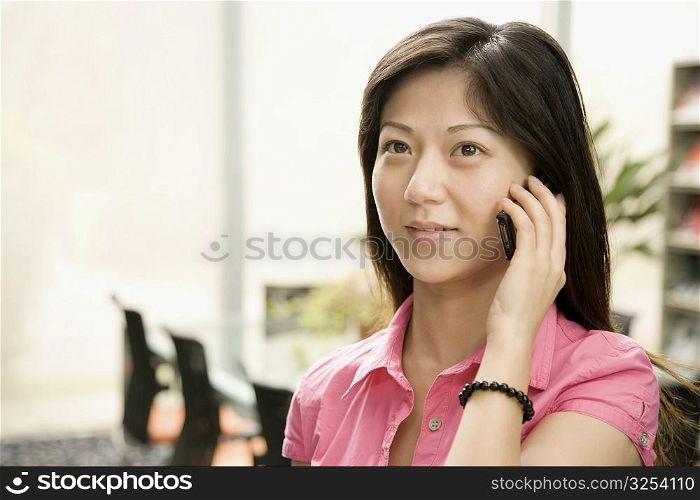 Close-up of a female office worker talking on a mobile phone