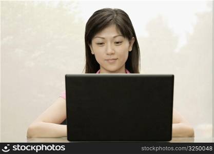 Close-up of a female office worker using a laptop