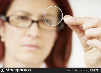 Close-up of a female optometrist holding a lens