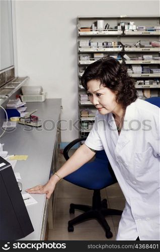 Close-up of a female pharmacist in a store room