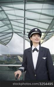 Close-up of a female pilot standing at an airport