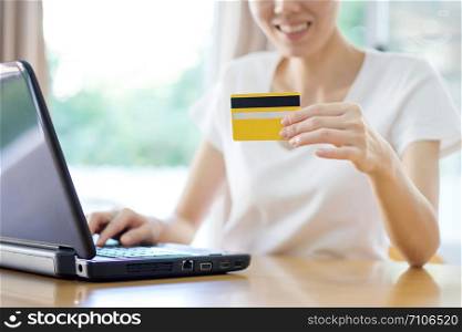 Close Up Of A female Shopping Online Using Laptop With Credit Card