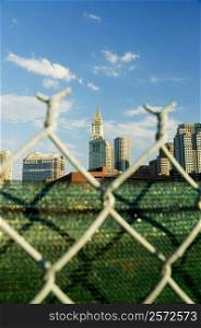 Close-up of a fence in front of buildings in a city, Boston, Massachusetts, USA