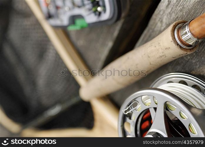 Close-up of a fishing reel and a fishing rod