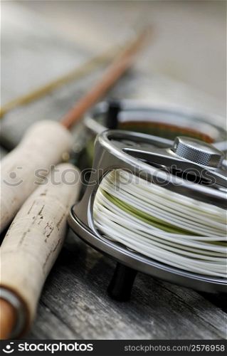 Close-up of a fishing reel and two fishing rods