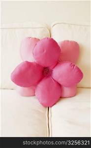 Close-up of a flower shaped cushion on a couch