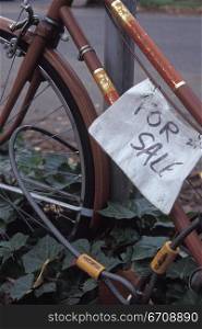 Close-up of a For Sale sign on a bicycle