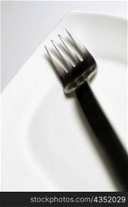 Close-up of a fork and a plate