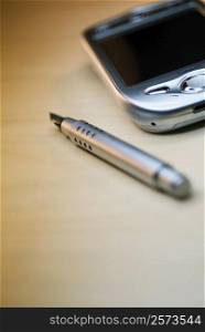 Close-up of a fountain pen with a personal data assistant