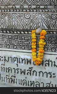 Close-up of a garland hanging on a wall, Nong Khai, Thailand