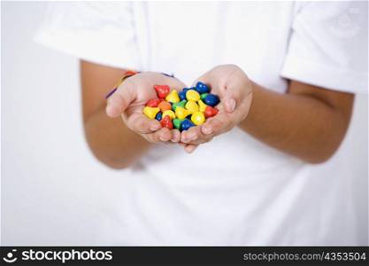 Close-up of a girl&acute;s hands holding candies