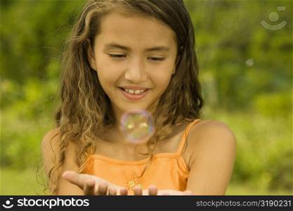 Close-up of a girl catching bubbles