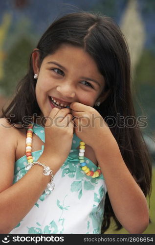 Close-up of a girl eating a candy necklace