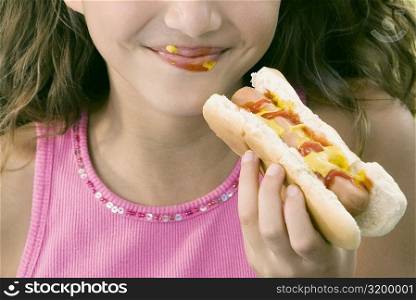 Close-up of a girl eating a hot dog