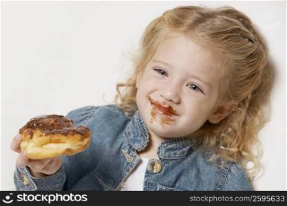 Close-up of a girl eating cake and smiling